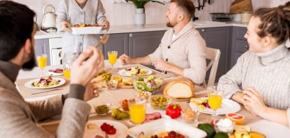 Group of friends enjoying a vibrant meal indoors, sharing laughter and good food.