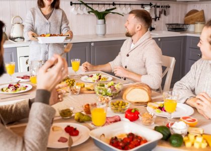 Group of friends enjoying a vibrant meal indoors, sharing laughter and good food.